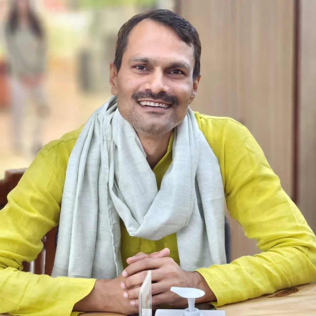 Anil Kumar Mahaseth smiling in a yellow kurta