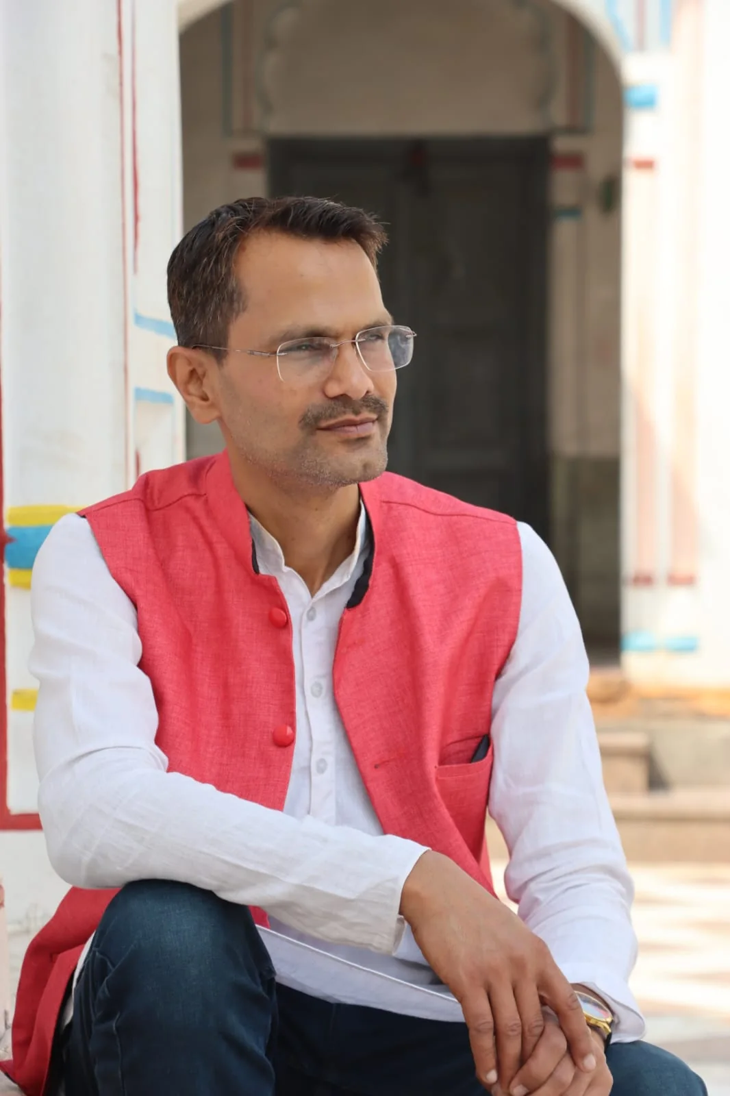 Anil Kumar Mahaseth seated at a temple in traditional dress